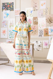 Woman in a colorful outfit standing in front of art displays